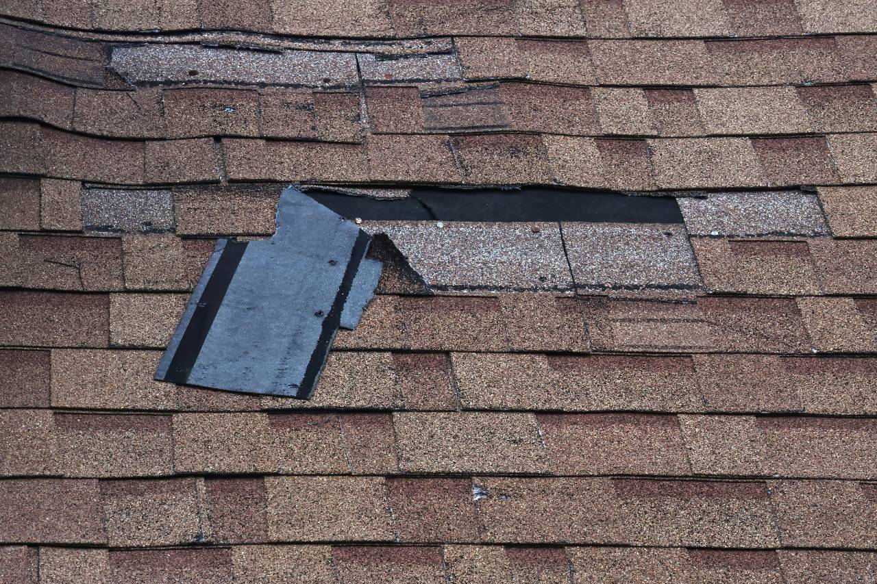 A wind-damaged roof that's part of an insurance claim.